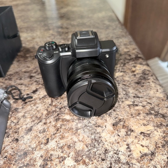 Compact Black Digital Camera with Detachable Lens Cap